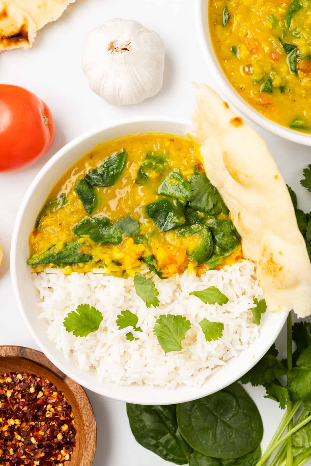 An overhead image of spinach dal served with white rice in a bowl.