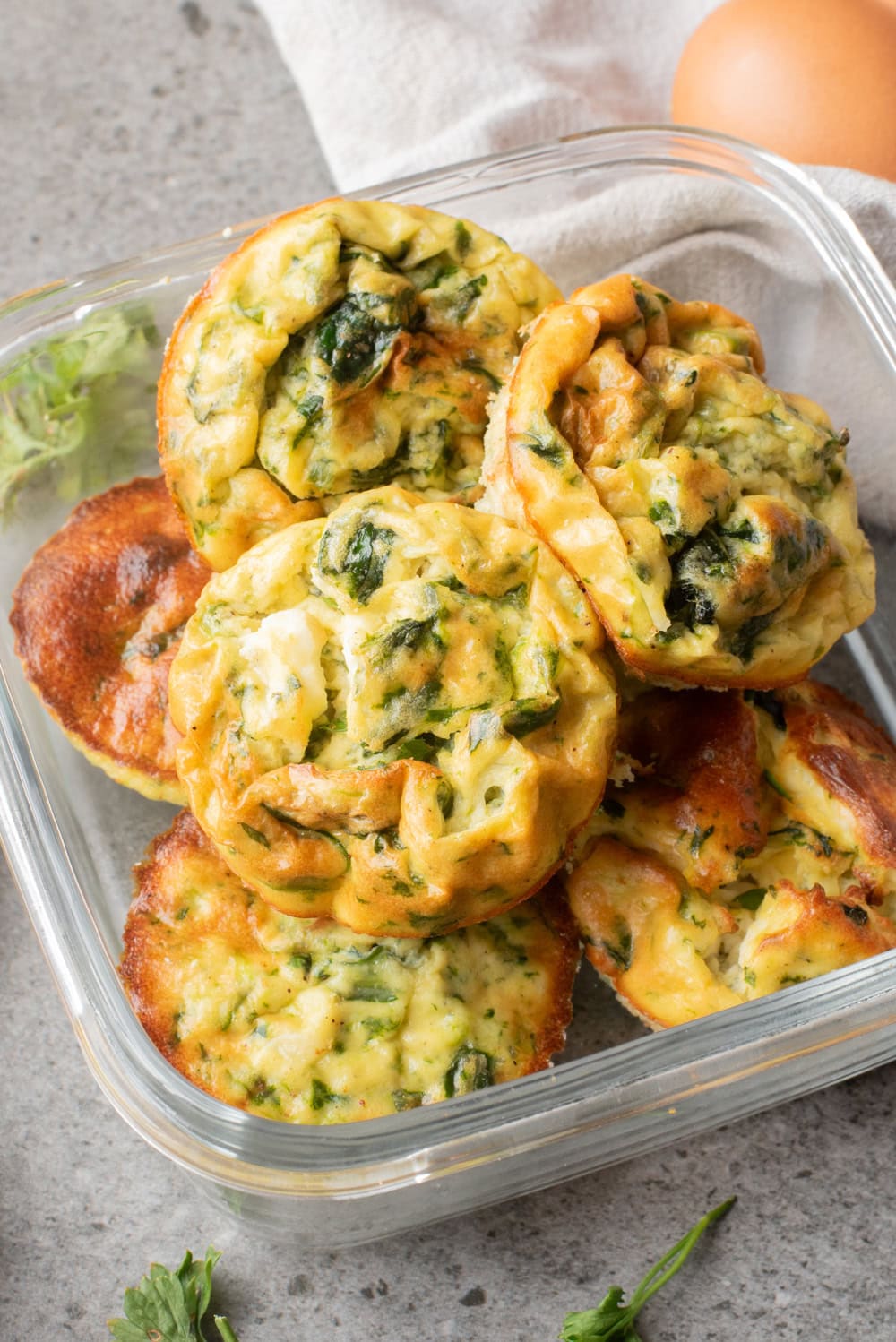 An overhead image of cottage cheese egg muffins in a container.
