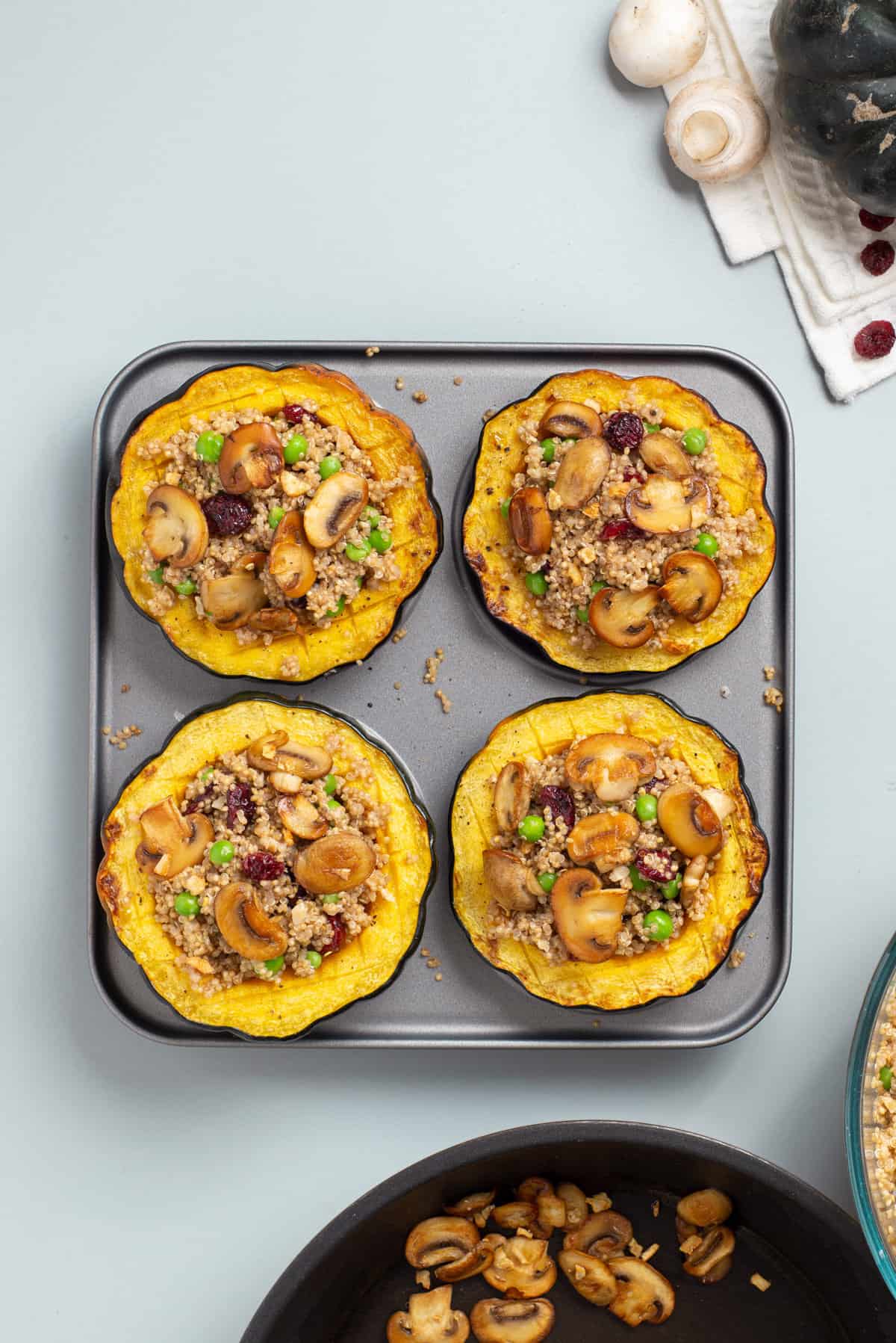 Overhead view of acorn squash halves filled with the quinoa mixture.