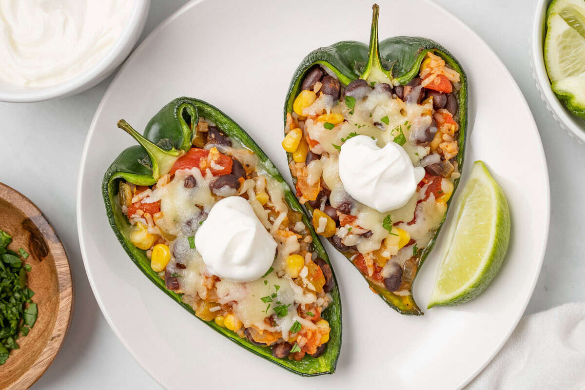 An overhead image of two pieces of stuffed poblano peppers served on a plate.