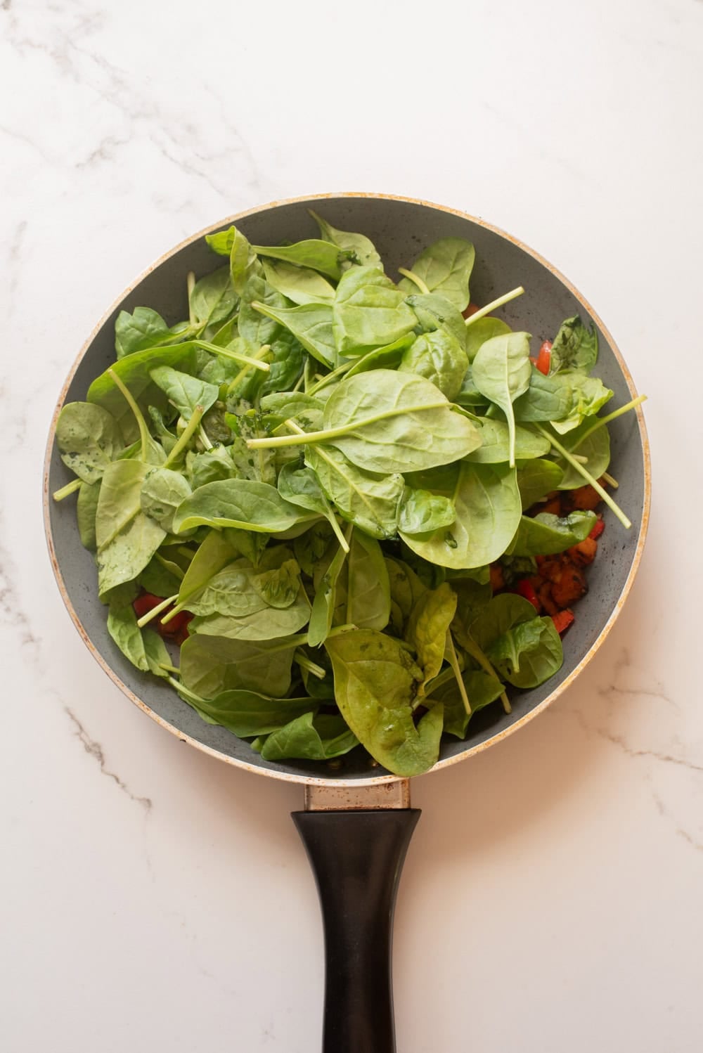 Fresh spinach added to the sweet potato hash.