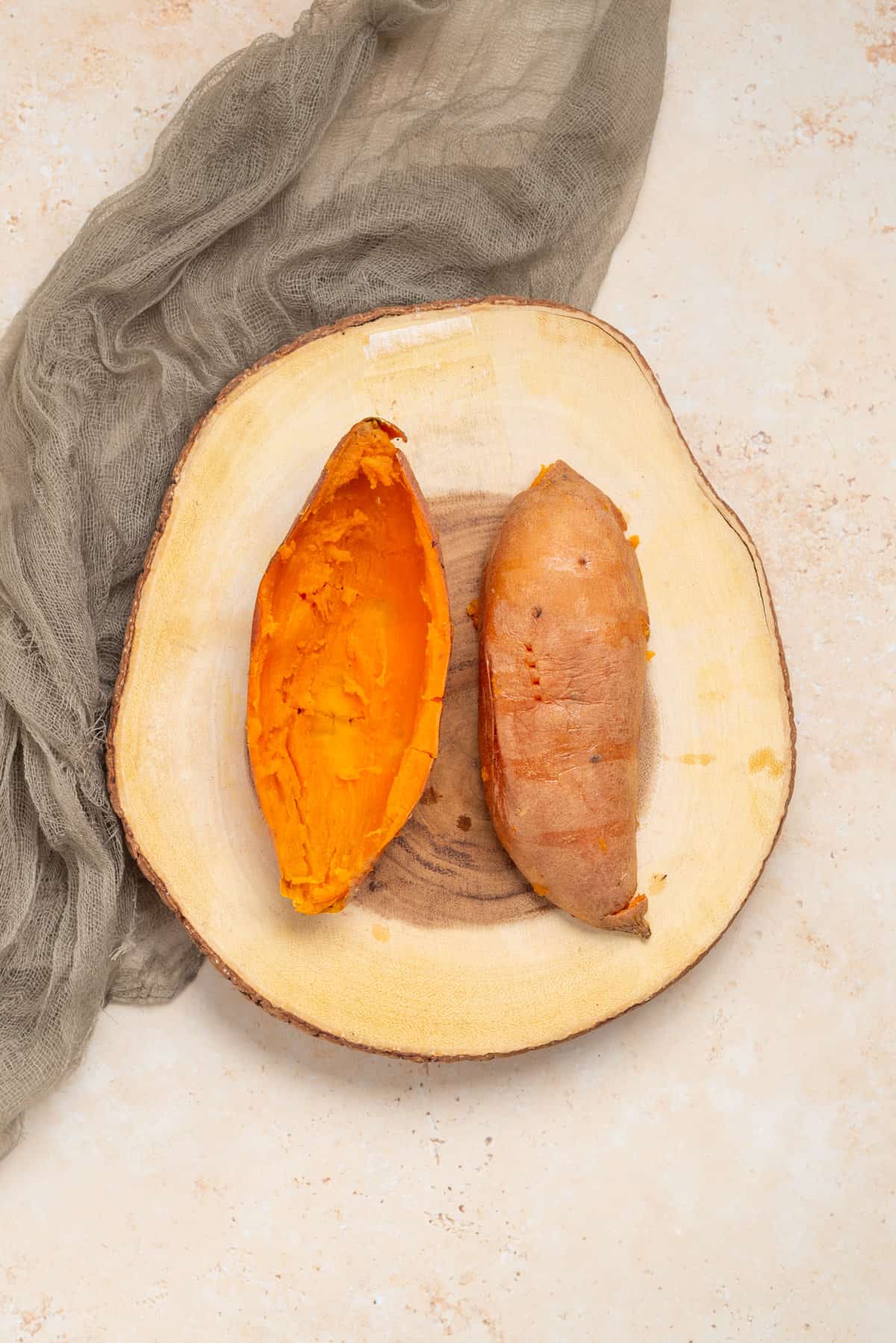 An image of sweet potato, sliced in half lengthwise.