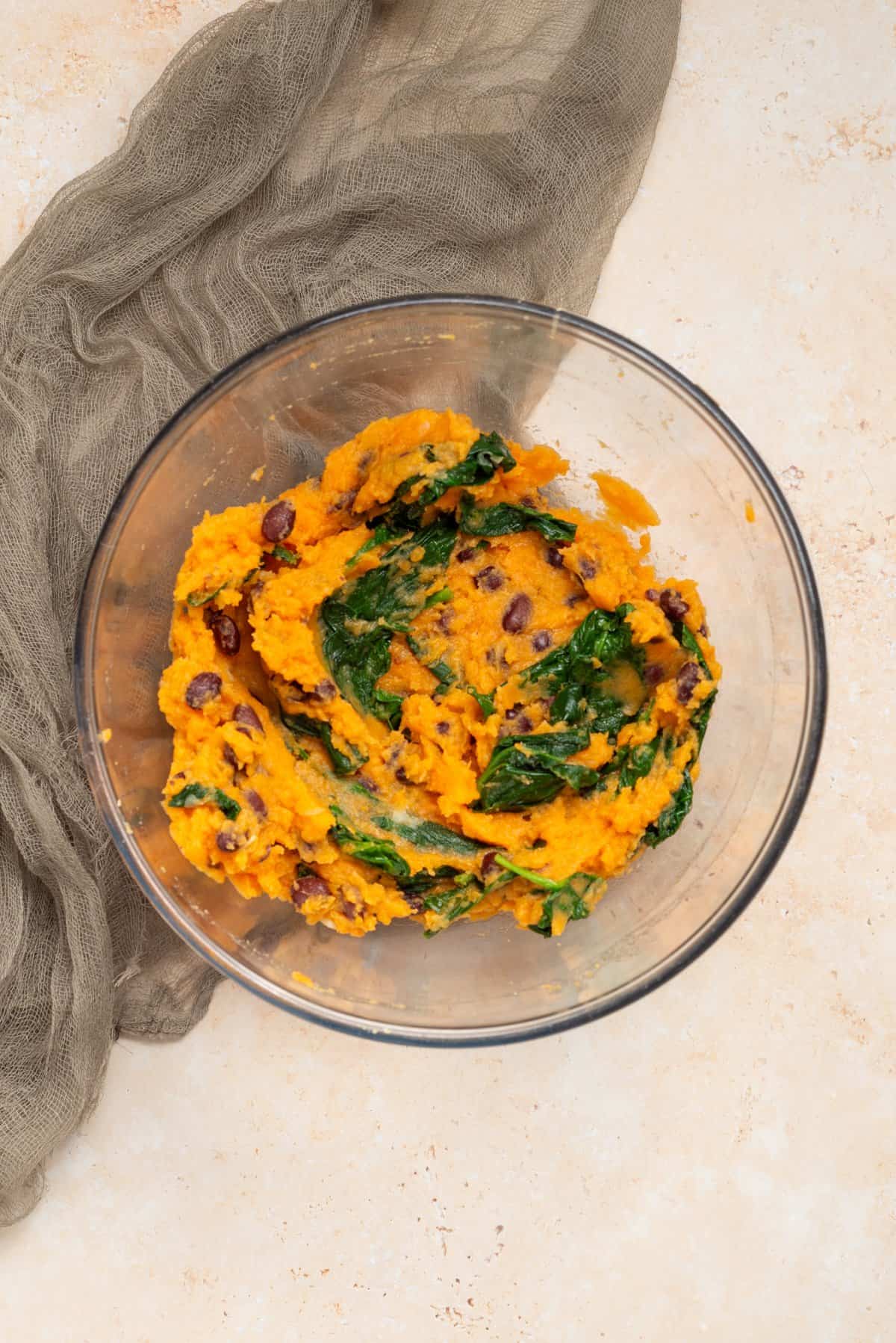 An overhead image of  mashed sweet potato filling mixed in a bowl.