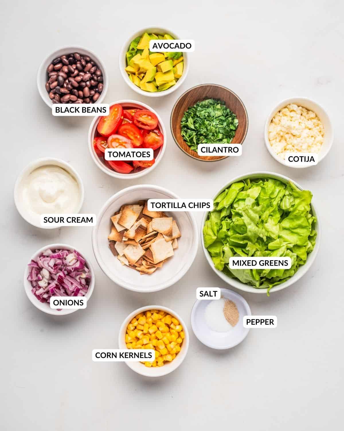 Overhead image of ingredients needed to make taco salad, labeled. Check recipe card for details. 
