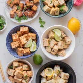 An overhead image featuring 6 bowls or different tofu flavored bowls.