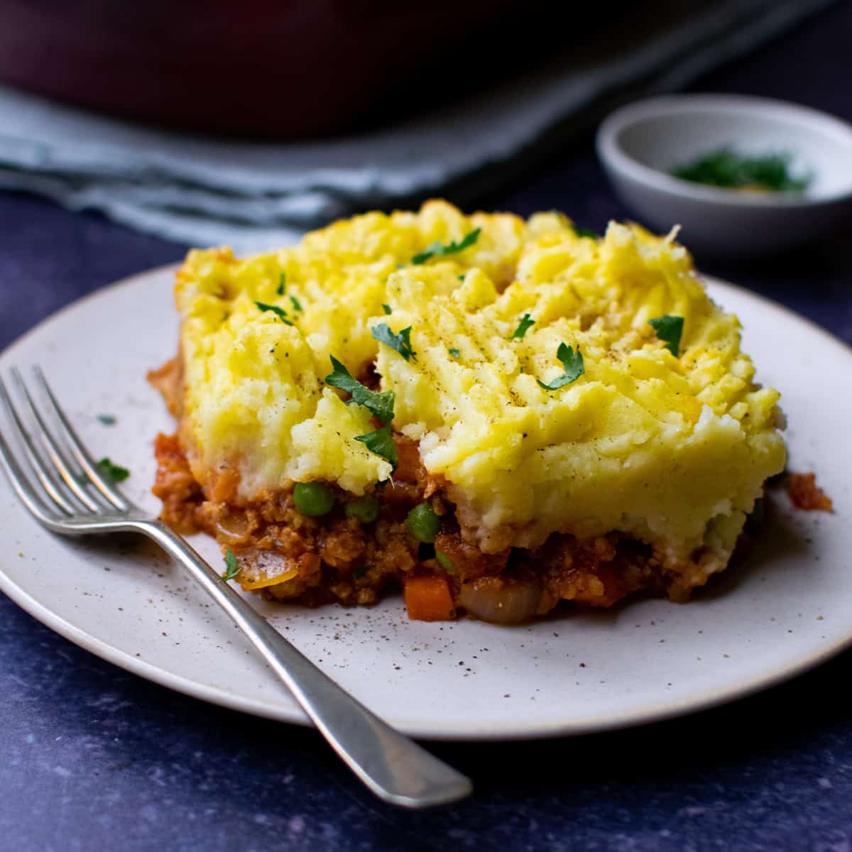 Close up of TVP Shepherd's Pie on white plate with fork.