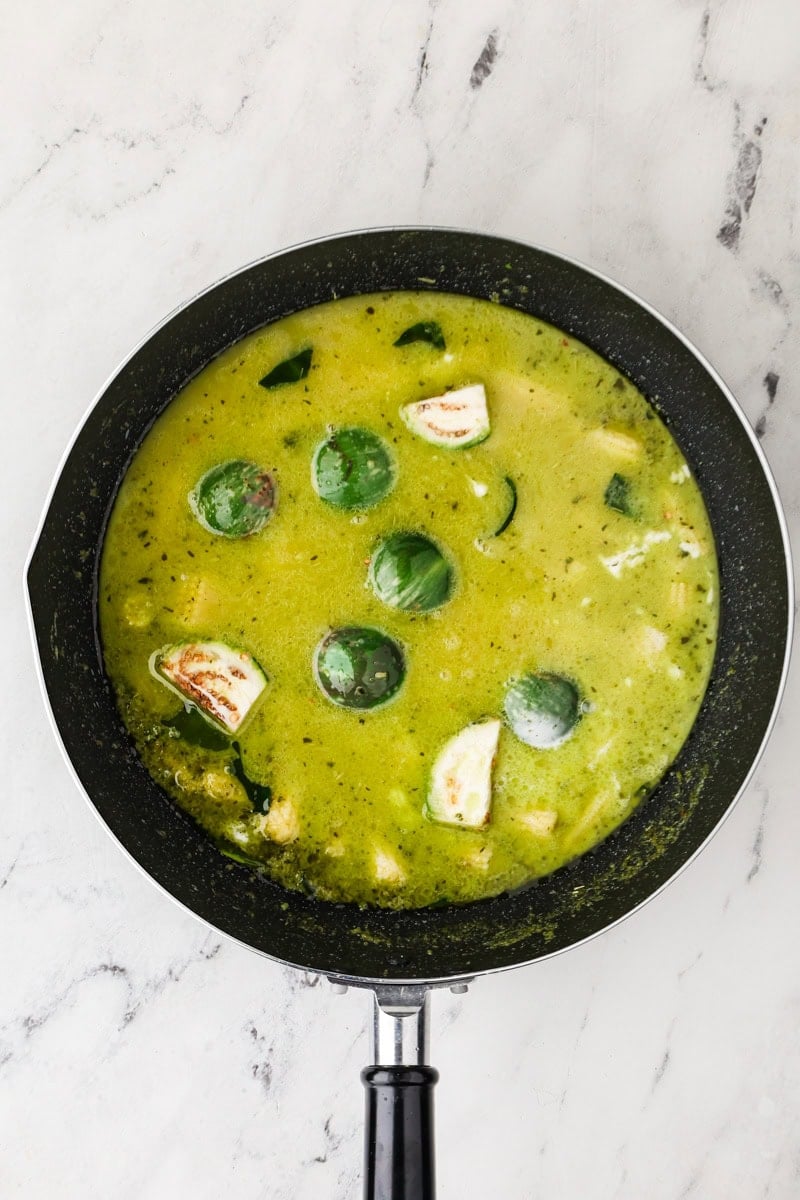 Aromatics and vegetables added in the pan for Thai green curry.