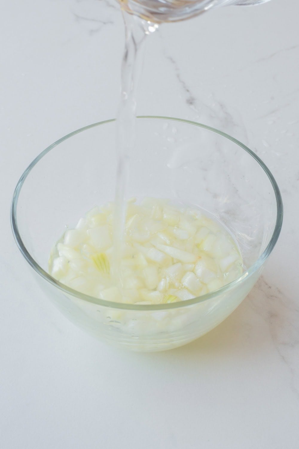 A close up image of soaking the onions in a bowl.