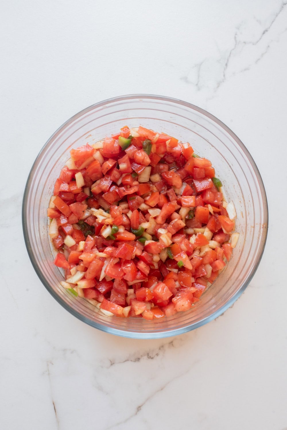 An overhead image of combining the ingredients of timatim in a bowl.