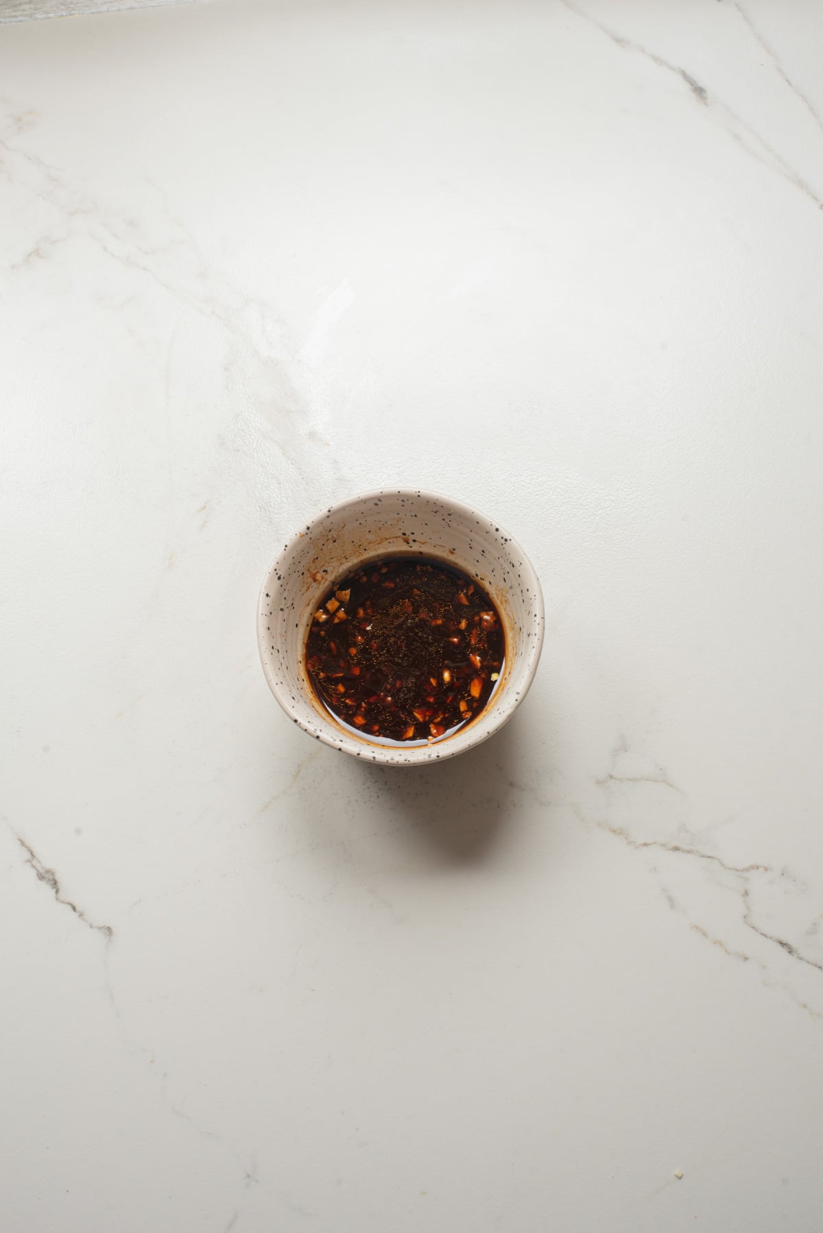 An overhead image of whisking the sauce together.