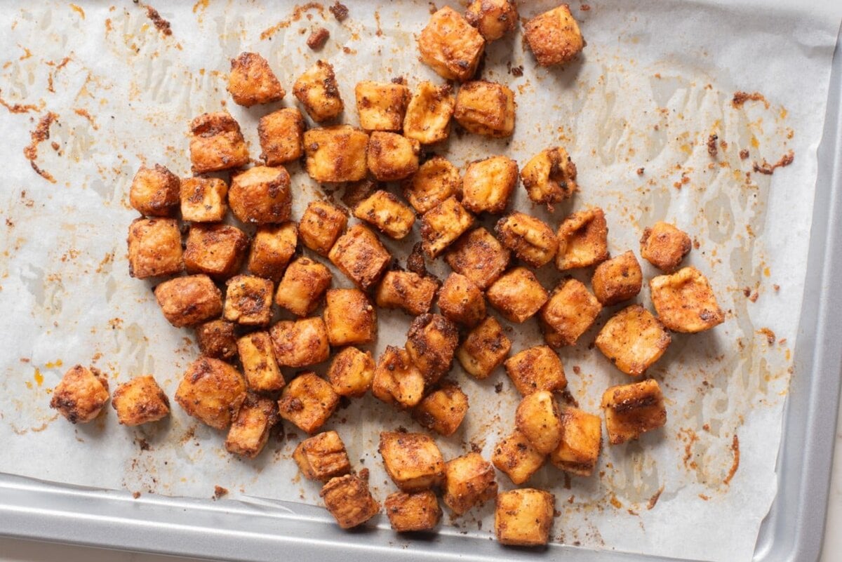 Crispy baked tofu croutons on a baking sheet.
