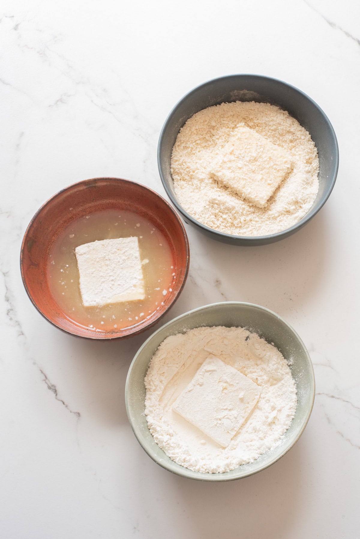 An overhead image of breading the tofu.