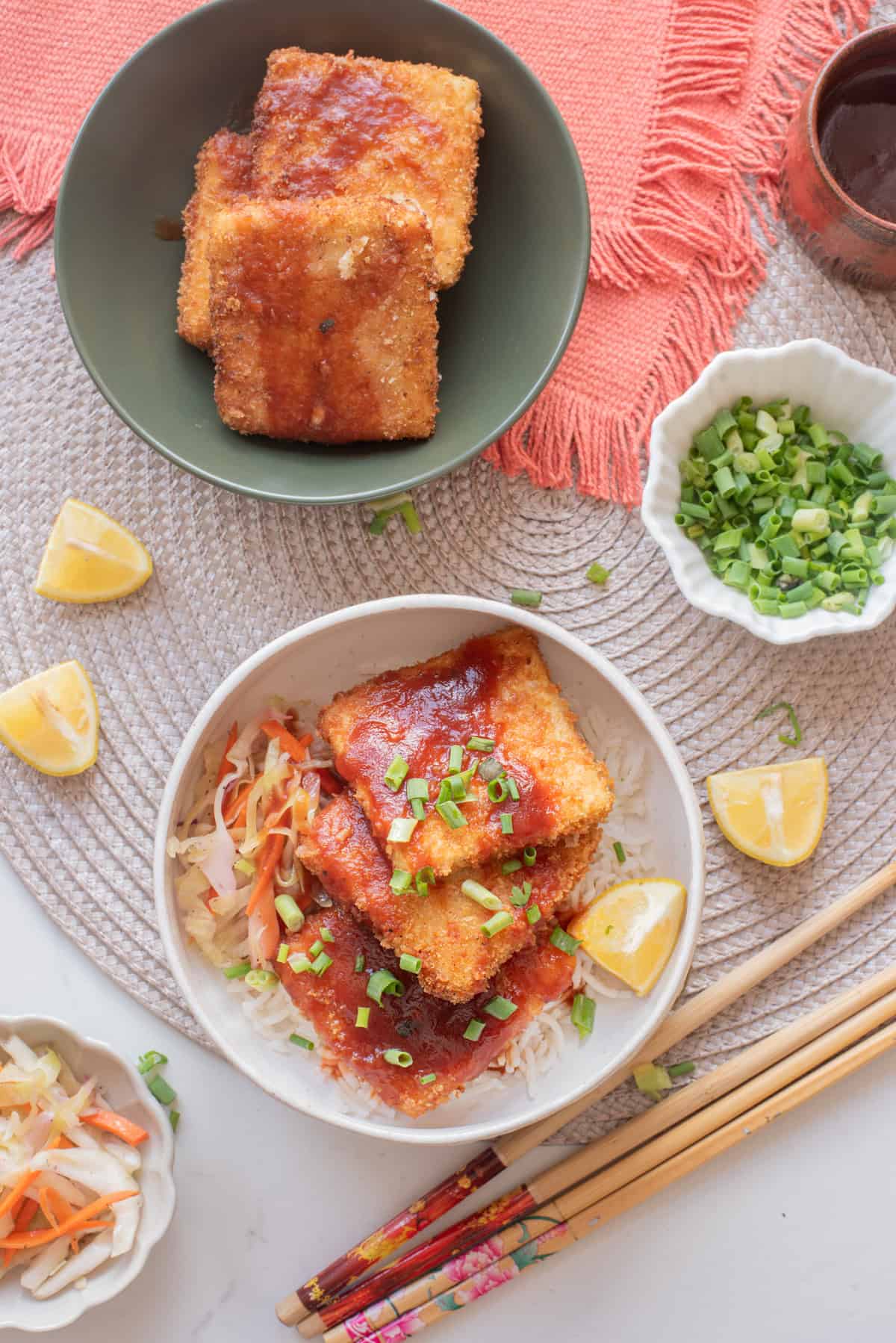 An overhead image of serving the tofu katsu in a bowl over slaw and rice.