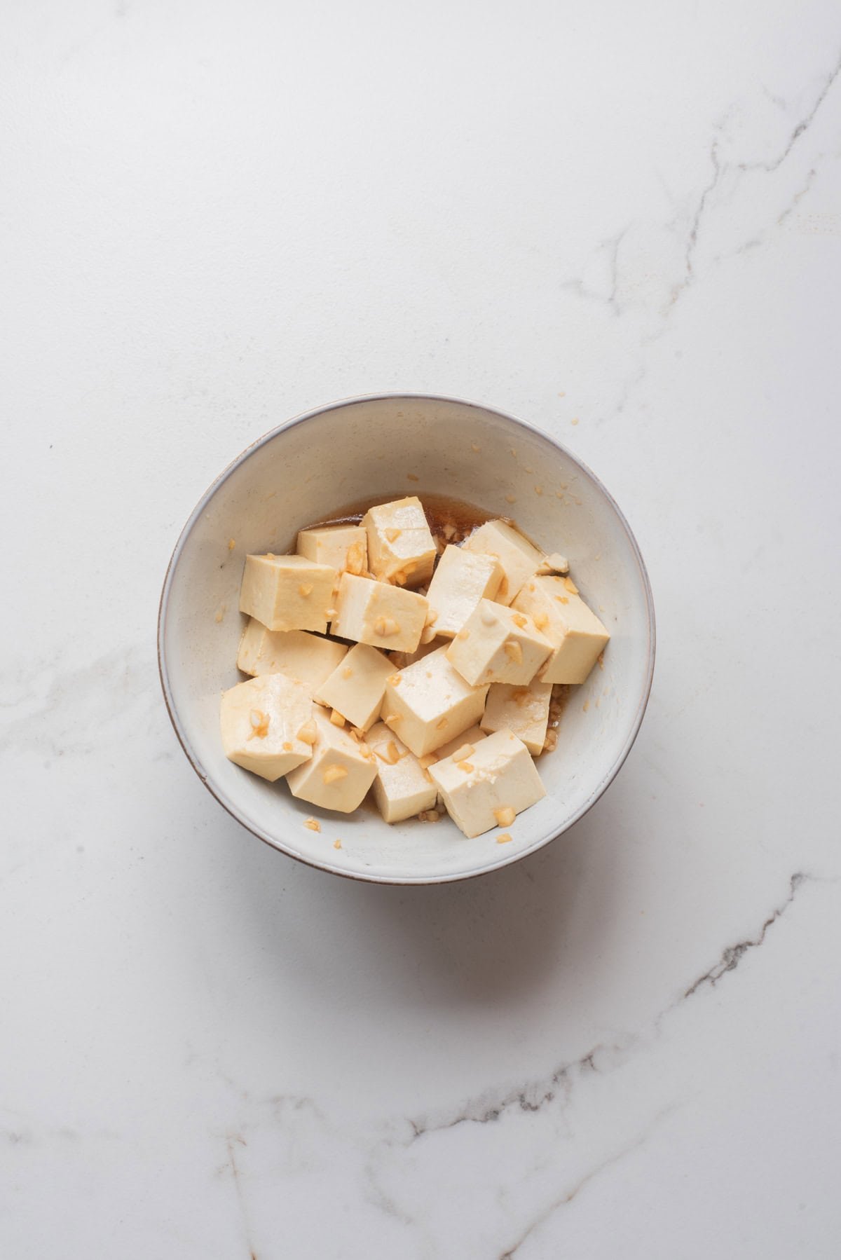 An overhead image of tofu marinated in honey garlic mixture.