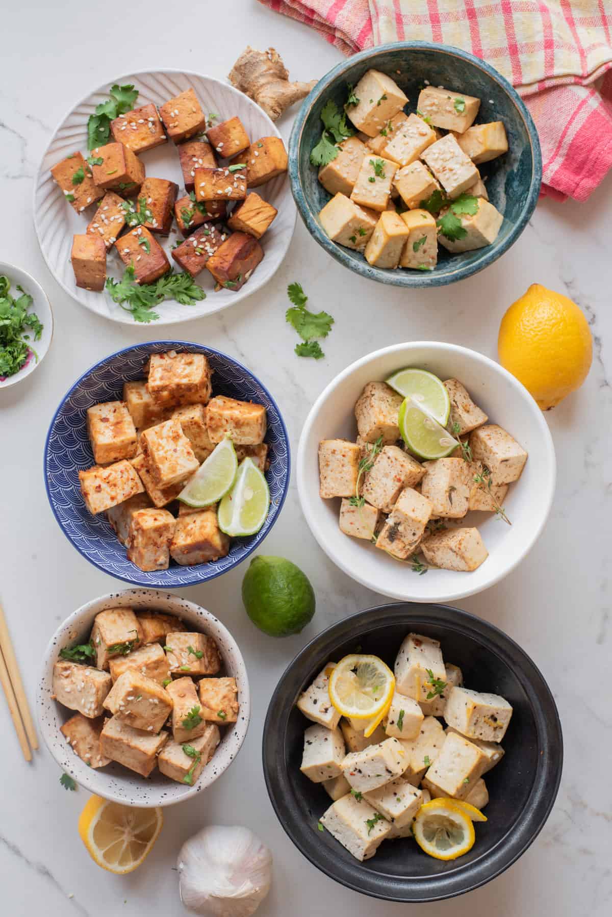 An overhead image featuring 6 bowls or different tofu flavored bowls.