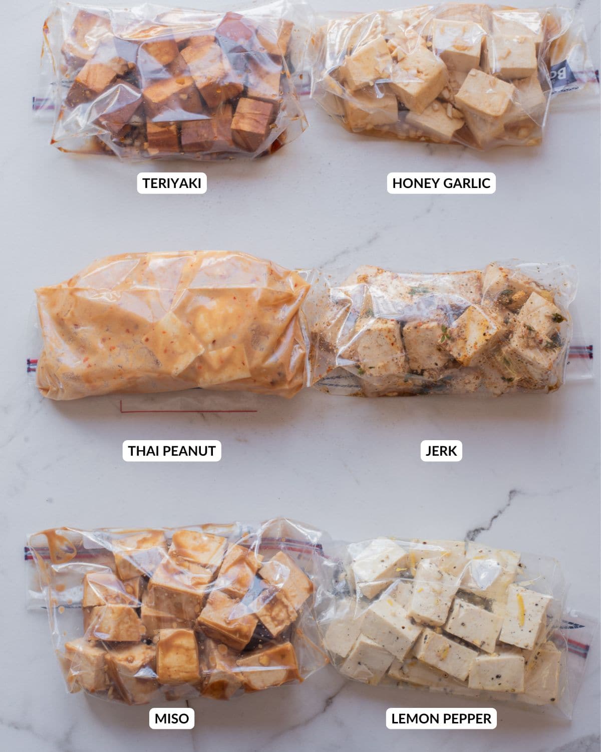 Overhead image of all six tofu marinades in ziplock bags.