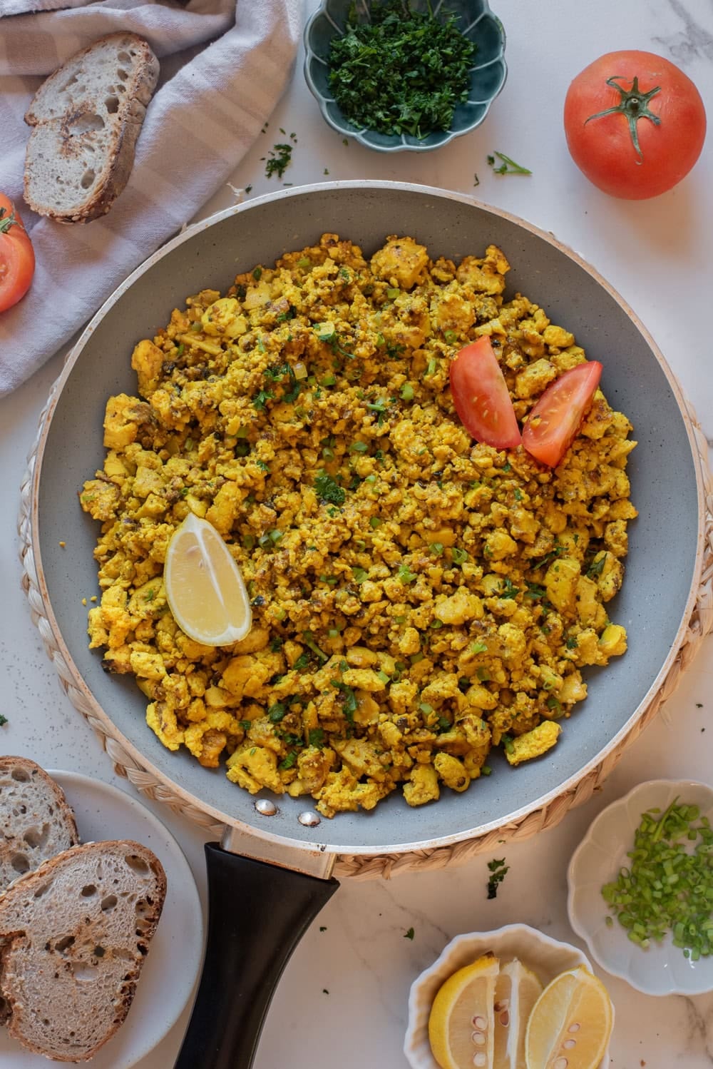 Finished tofu scramble garnished with herbs and ready to serve.