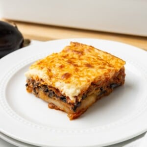 A close up image of vegetarian moussaka served on a plate.