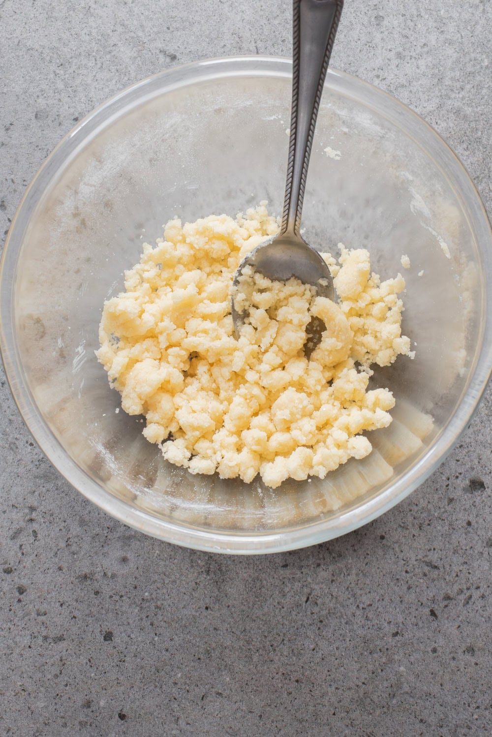 An overhead image of making the streusel topping in a bowl.