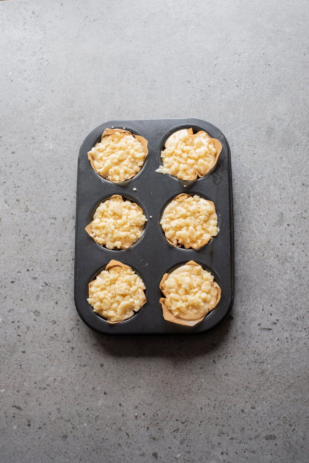 An overhead image of dividing the batter into muffin cups.