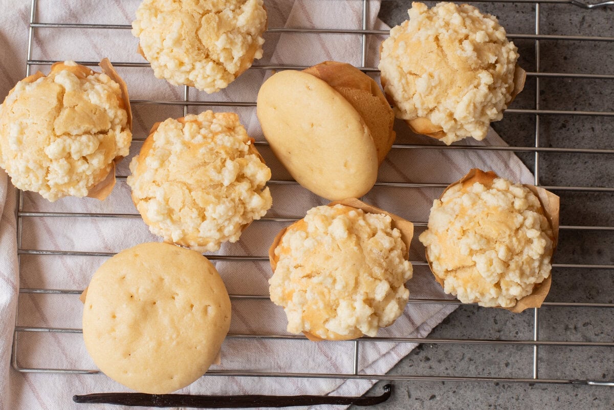 An overhead image of vanilla muffins on a wire rack.