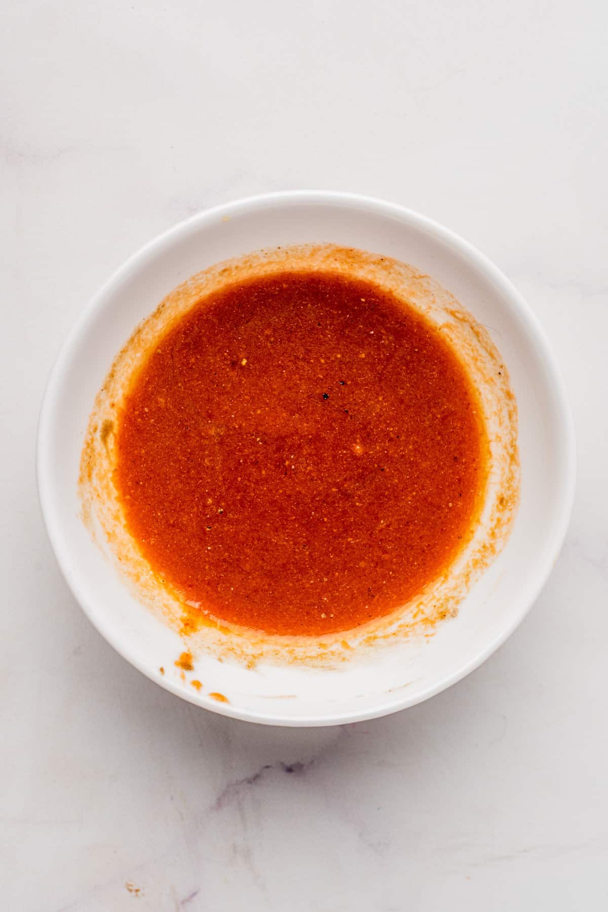 An image of a bowl of homemade buffalo sauce