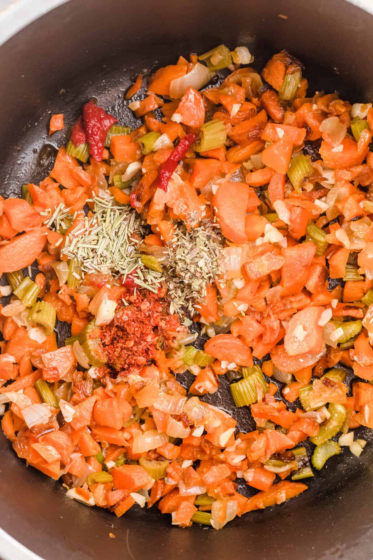 Overhead shot of spices added to mirepoix.