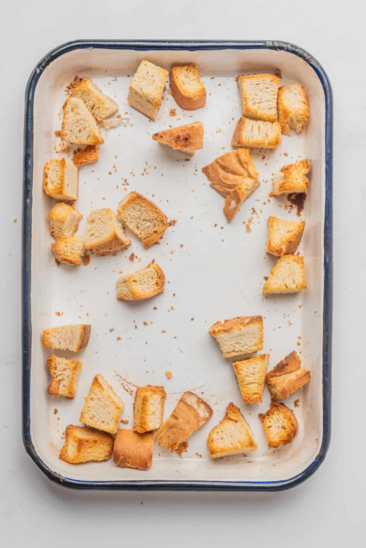 An image of crusty bread on a baking sheet after baking.
