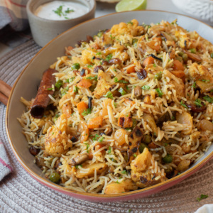 Close-up of vegetable biryani with cauliflower, carrots, peas, and fragrant basmati rice.
