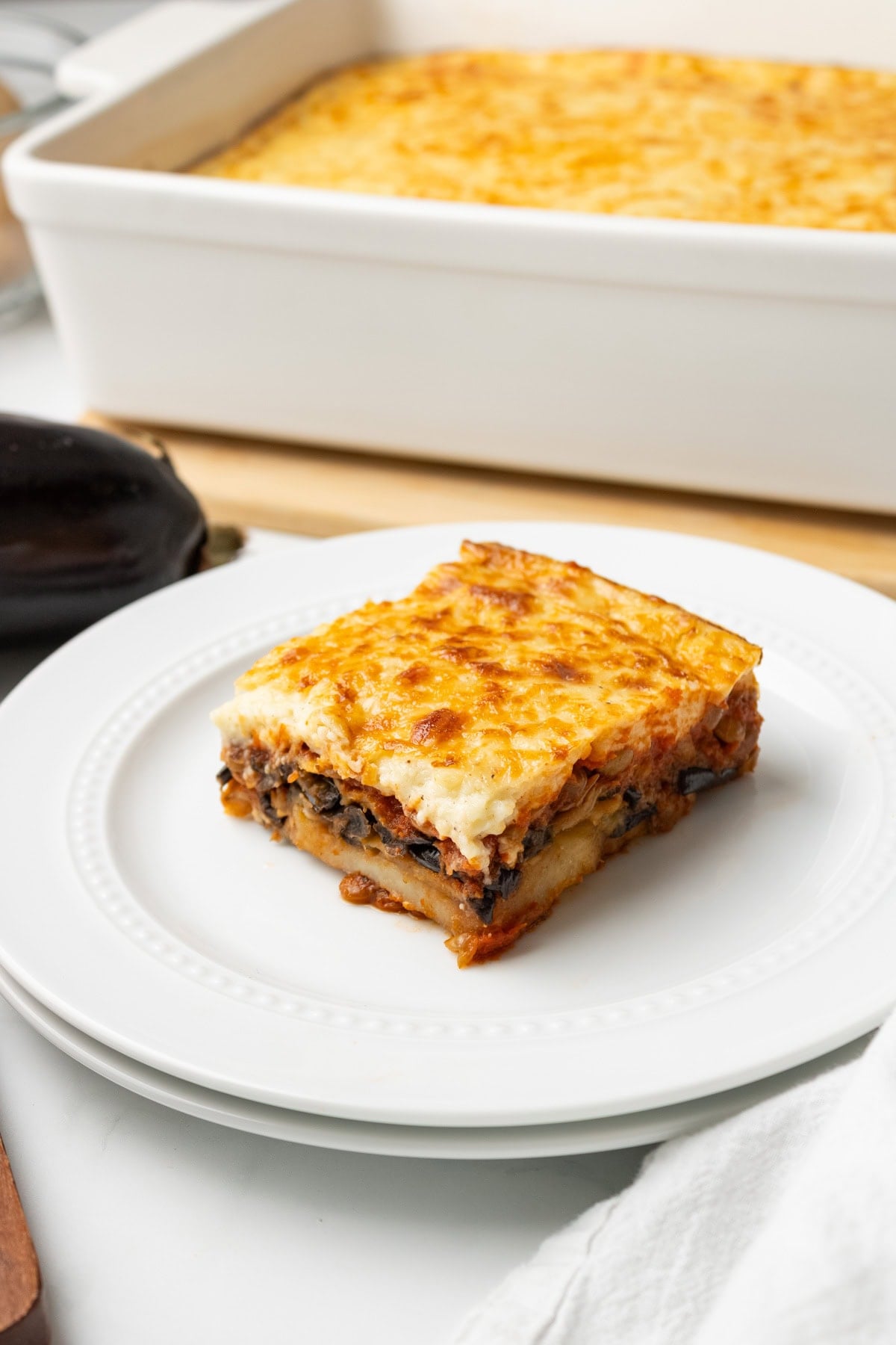 A close up image of vegetarian moussaka served on a plate.