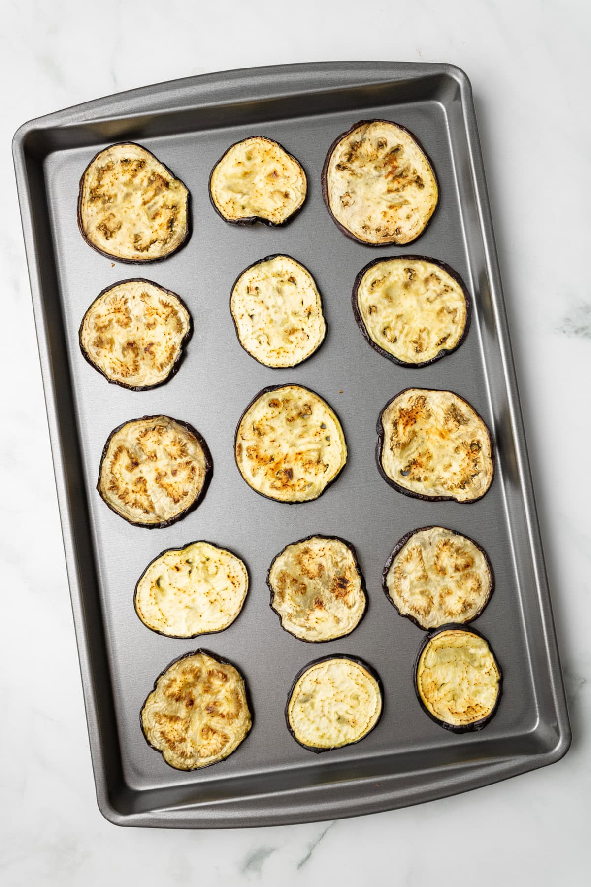 An overhead image of roasted eggplant slices.