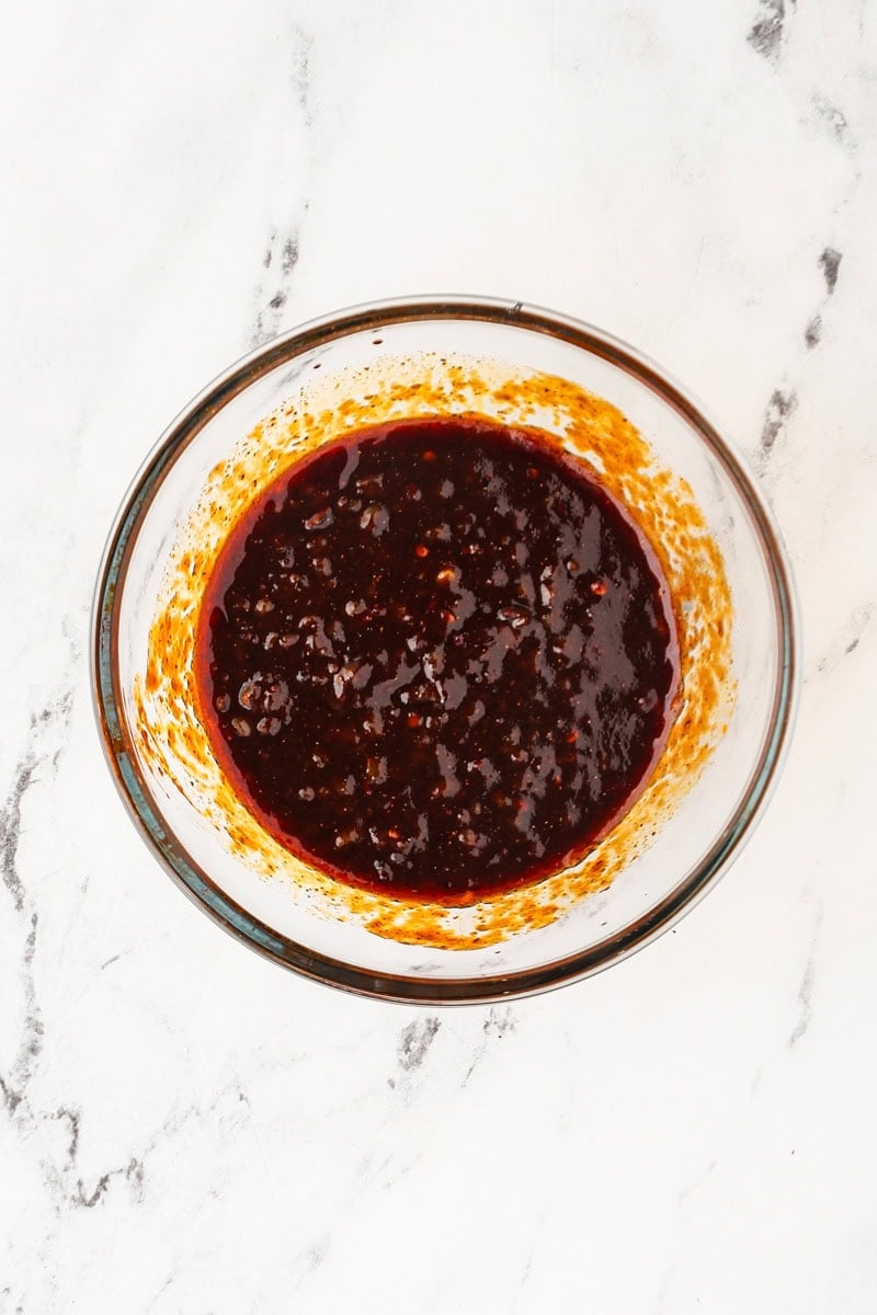 Mixing pad thai sauce in a bowl.