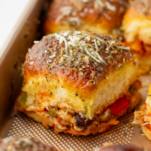 A close up image of a piece of pizza slider on the baking sheet.