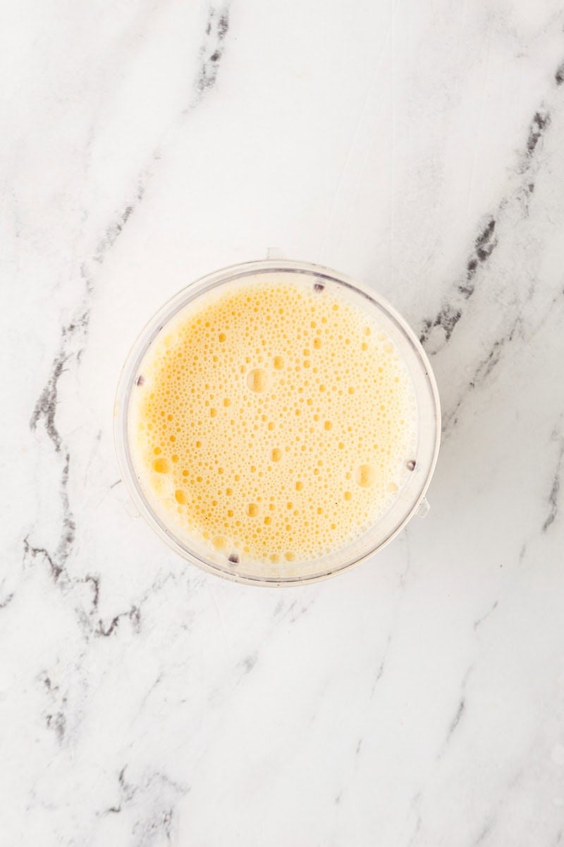 An overhead image of blending together the eggs, cottage cheese and milk.