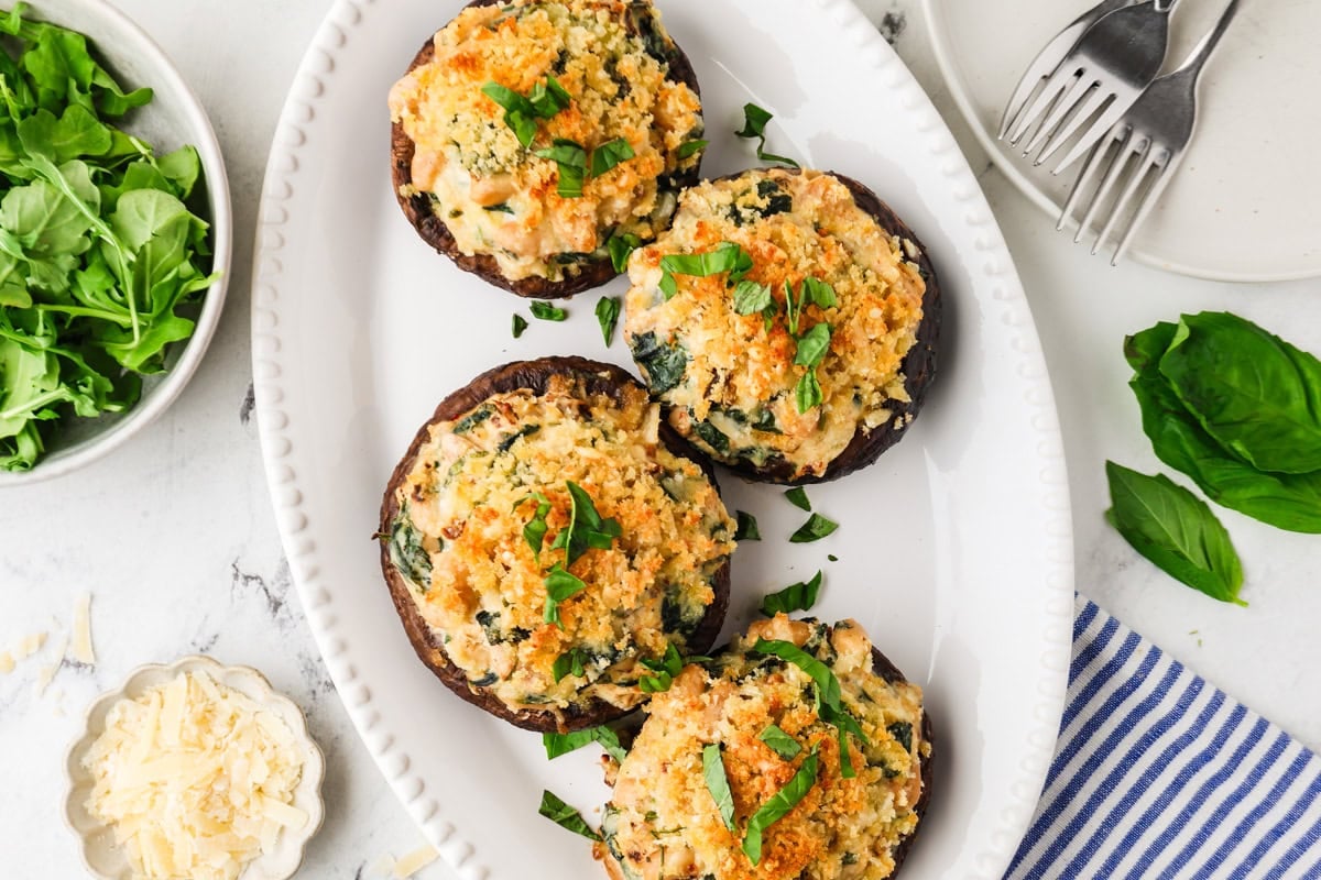 An overhead image of vegetarian stuffed portobello mushrooms on a plate.