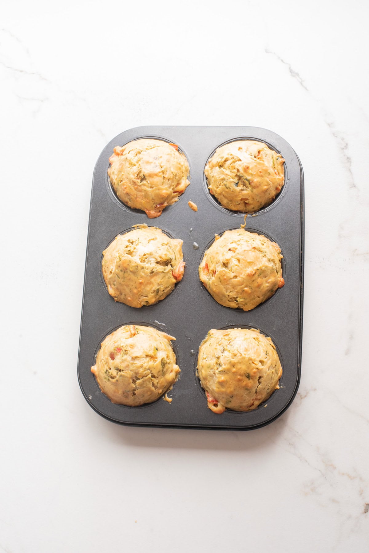 An overhead image of baked veggie muffins.