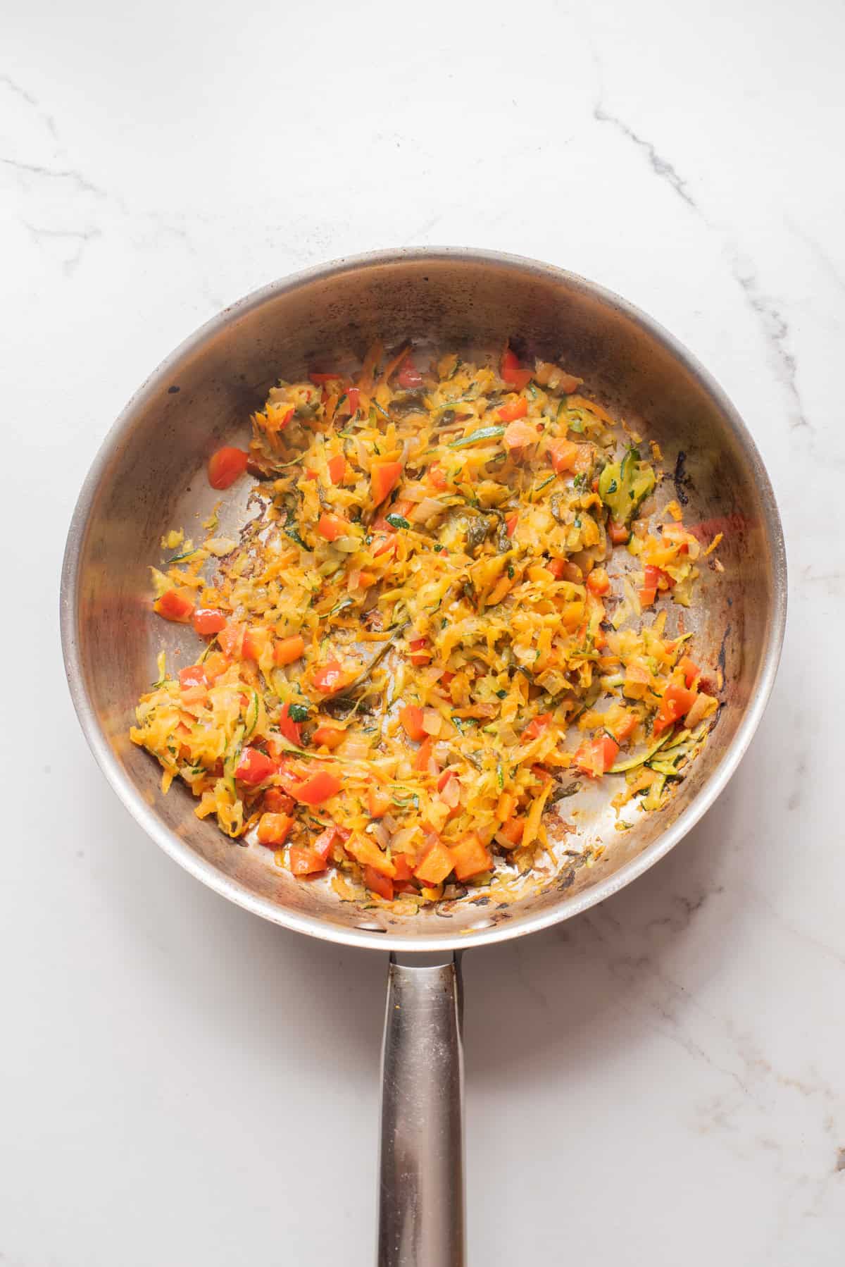 An overhead image of sautéing the veggies on a skillet.