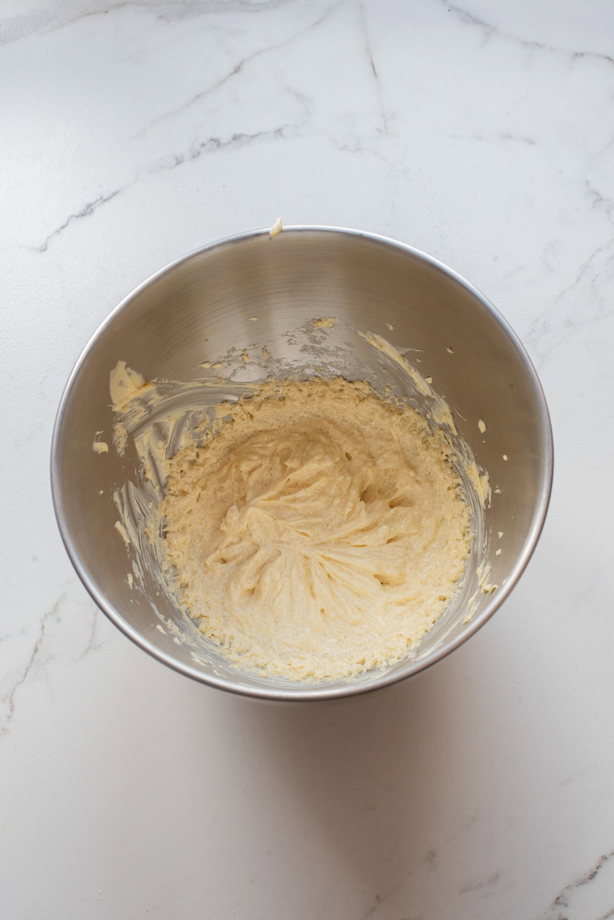An overhead image of mixing the wet ingredient batter together in a bowl.