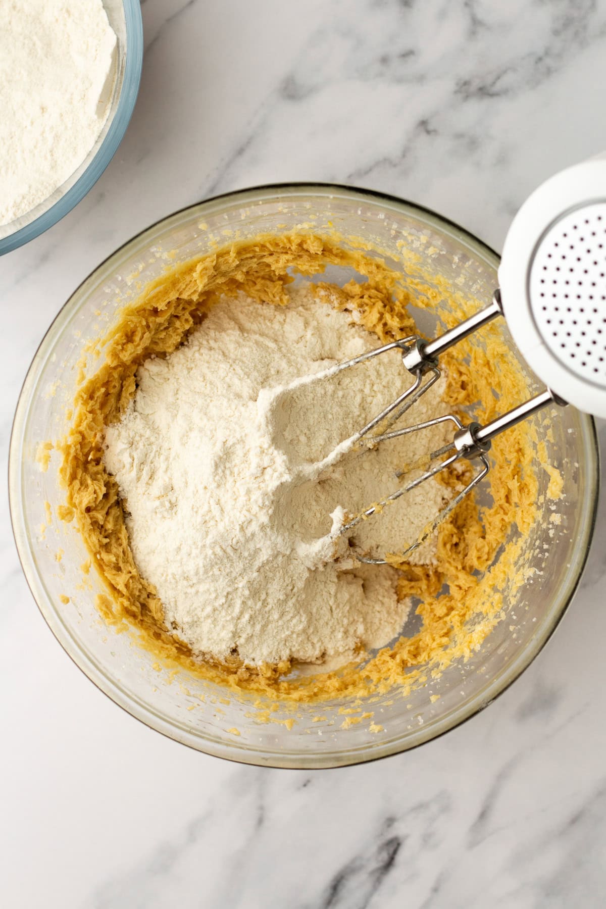 An overhead image of mixing the dry ingredients with the wet ingredients in a bowl.