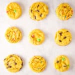 Overhead view of 9 yellow cake mix cookies on a white marble background.