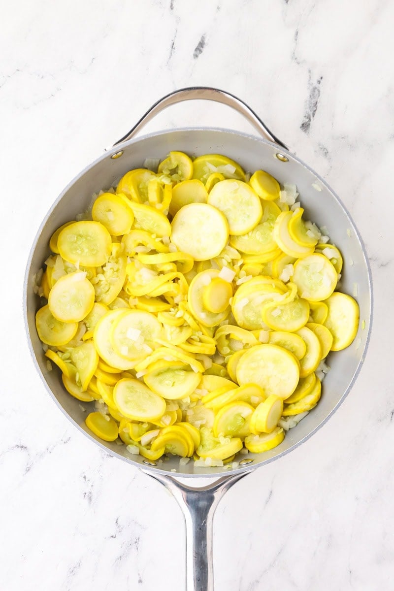 Yellow squash and onion cooked together in a skillet until softened.