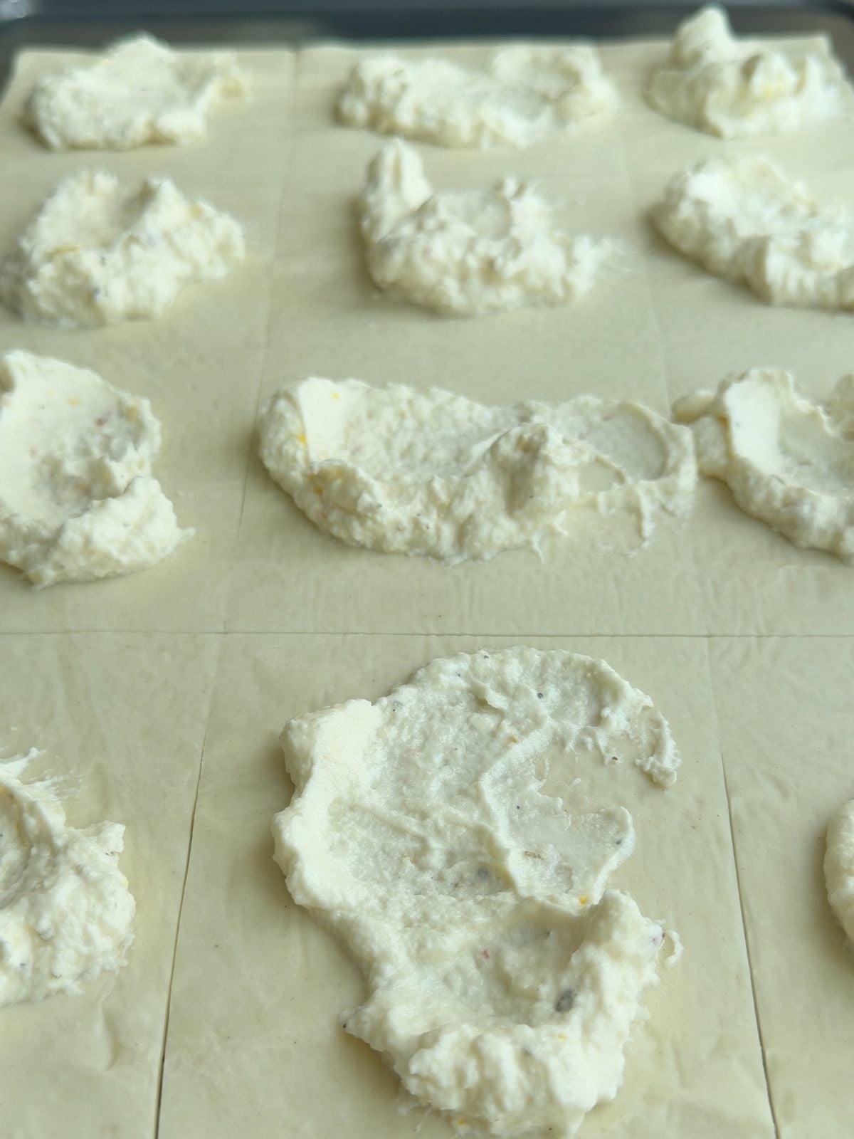 Lemon ricotta spread over prepared puff pastry before adding zucchini.