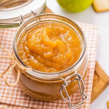 Close up of apple butter in a glass jar.