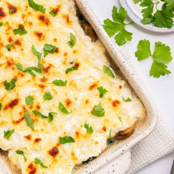 An overhead image of spaghetti squash casserole with fresh basil leaves on top.