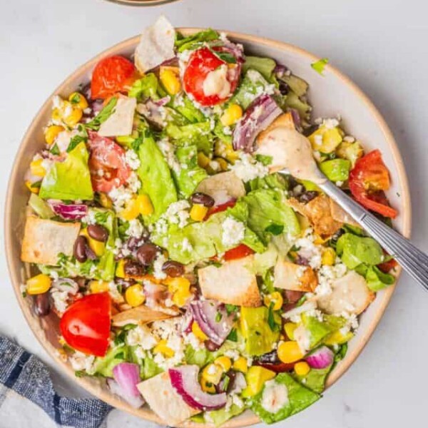 An overhead image of veggie taco salad in a bowl with a fork.