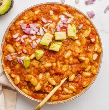 An overhead image of vegan white bean chili with toppings
