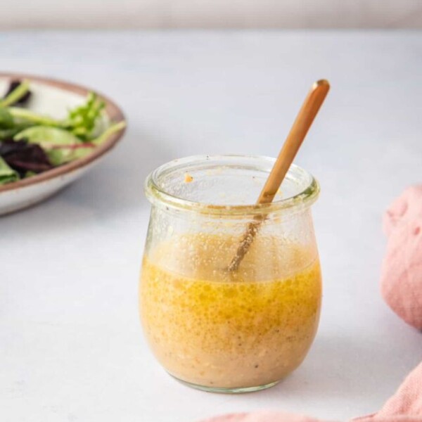 An image of white wine vinaigrette with a spoon.