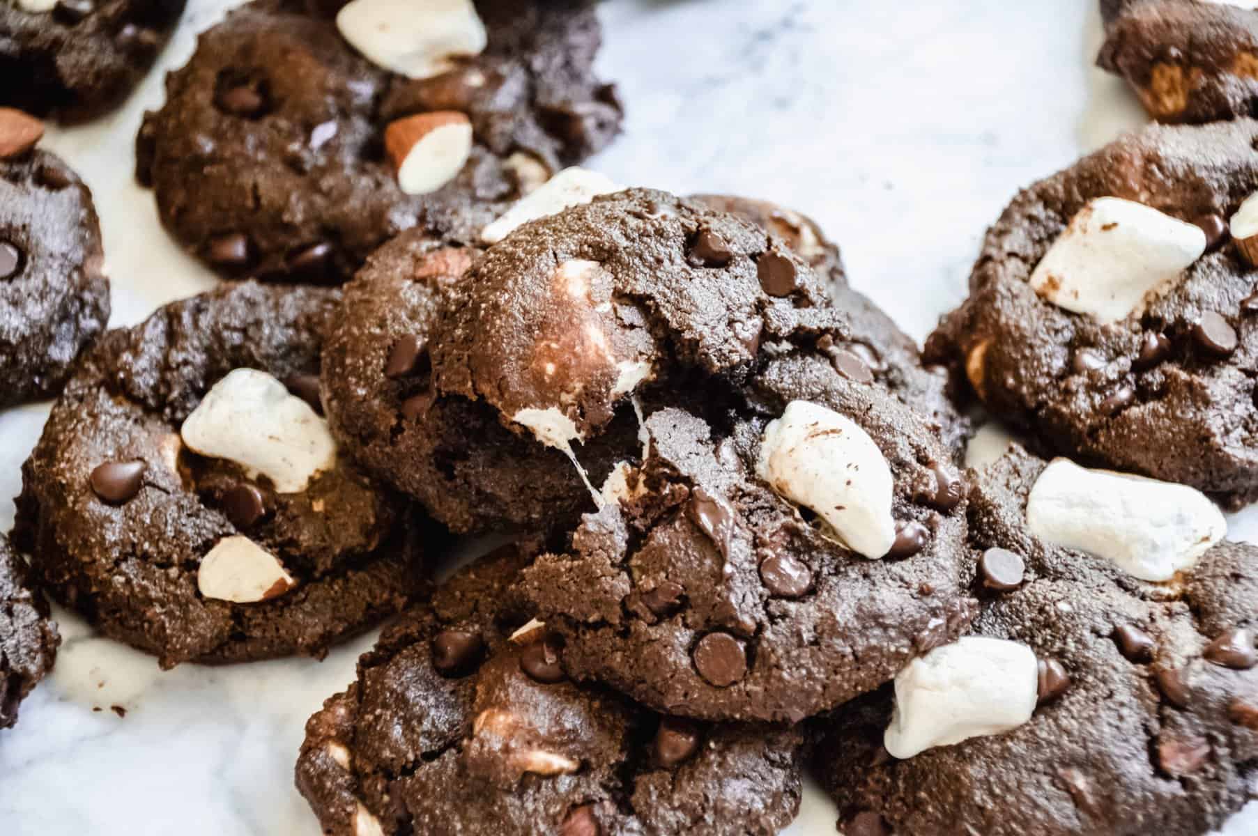 A close up straight view of several vegan rocky road cookies.
