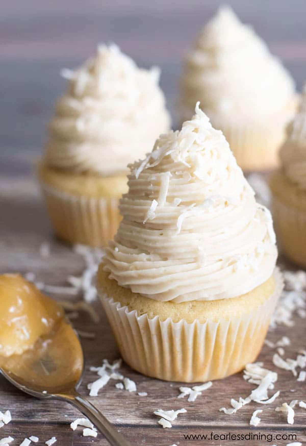 A straight shot of gluten-free lemon curd filled cupcakes topped with buttercream frosting.
