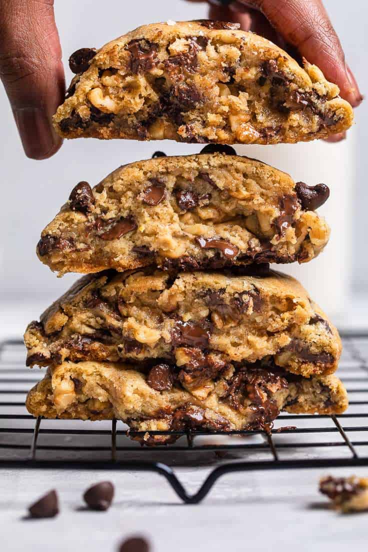 A straight photo of stacked vegan levain chocolate chip cookies.